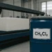 a blue drum of methylene chloride in a foam manufactory next to a machine