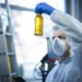 Professional engineers in full PPE demonstrating phenol safety and handling in an industrial chemical plant.